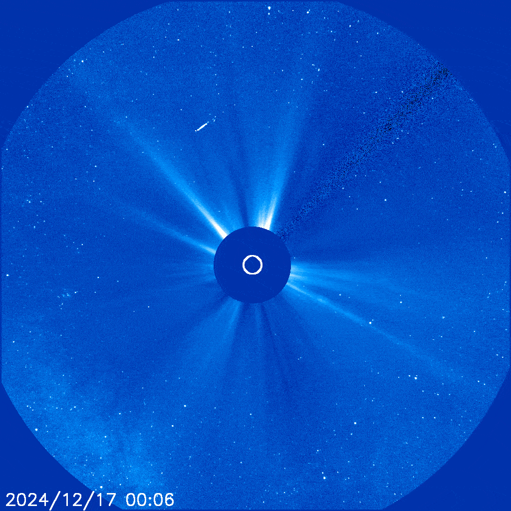 The Sun is cover by the coronagraph and it is releasing wispy arcs of plasma - two cms are emitted around 7 oclock of the image before a circular cme is seen spreading very quickly across the view