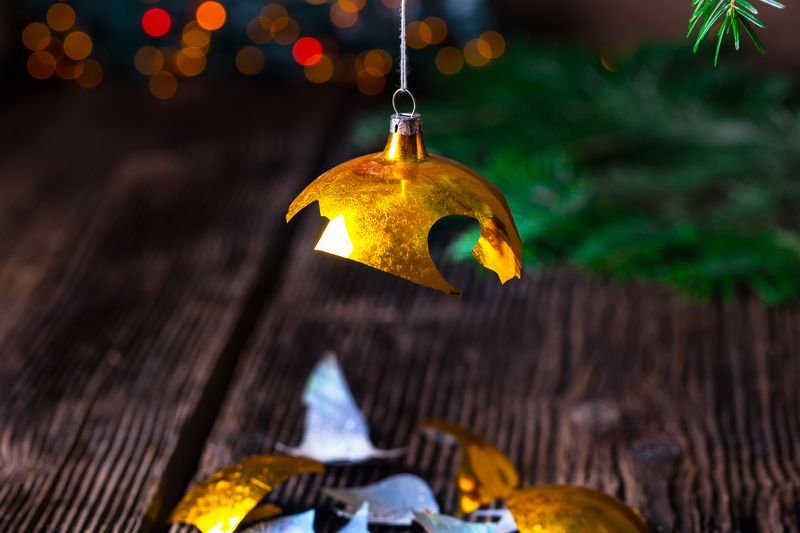 broken gold christmas bauble handing on a tree