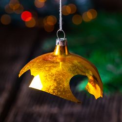 broken gold christmas bauble handing on a tree