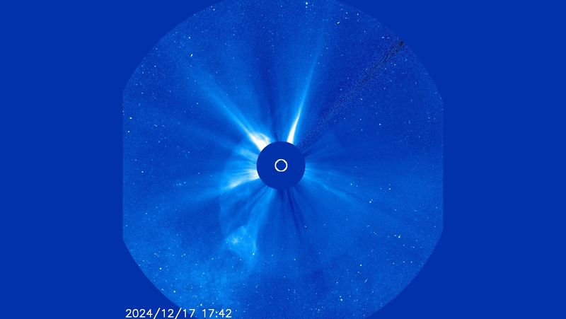 The sun is blocked by a coronagraph. a bubble of plasma is seen stretching around it.