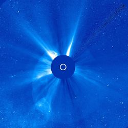 The sun is blocked by a coronagraph. a bubble of plasma is seen stretching around it.