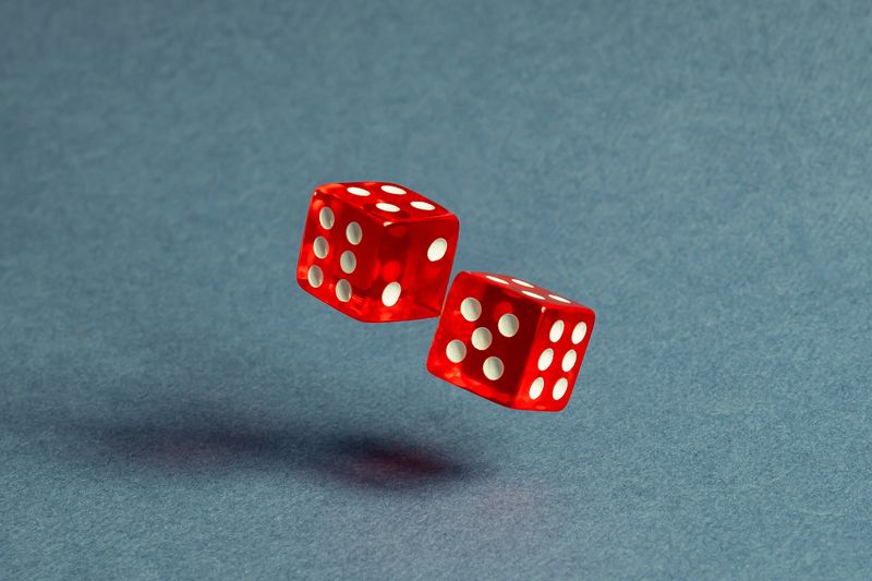 Two red dice with numerical values lie in a chaotic order.