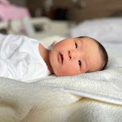Baby born from the fertile procedure, lying on a blanket. 
