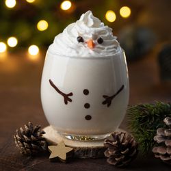 Delicious Christmas eggnog in glass. Creative snowman cocktail idea for Christmas and New Year Eve, copy space