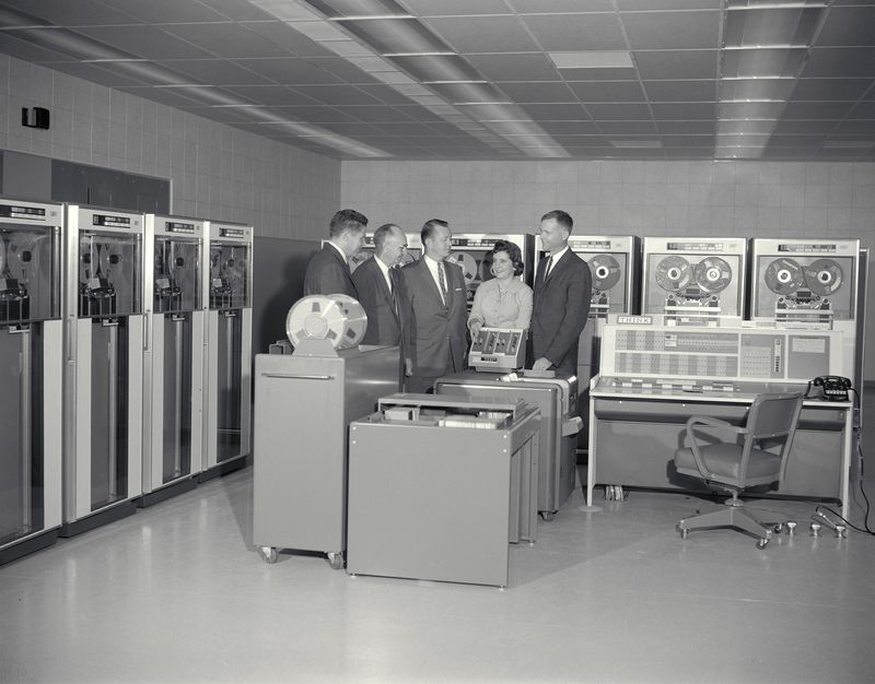 An IBM 7090 at the NASA Ames Research Center in 1961, with the director of Ames and several IBM employees