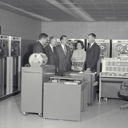 An IBM 7090 at the NASA Ames Research Center in 1961, with the director of Ames and several IBM employees