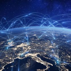 Image of Europe at night on a globe, with arcing blue lines linking various locations