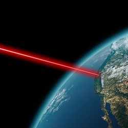 A red laser beam beams out into space from an earth satellite showing California