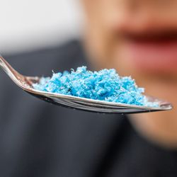 representation of microplastics in food, small particles of blue plastic on a spoon