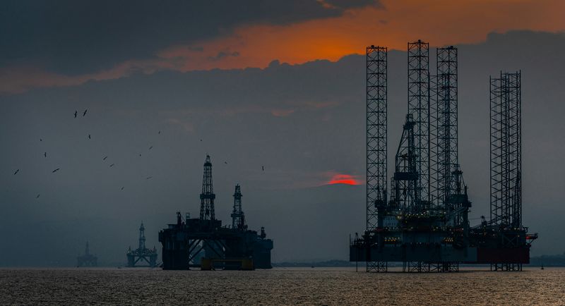 Sunset over the oil rigs of Cromarty Firth on the Scottish coast.