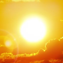 bright sun against an orange sky with clouds