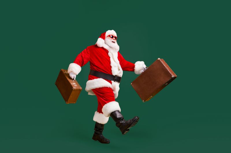 Santa travelling with some bags.