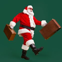 Santa travelling with some bags.