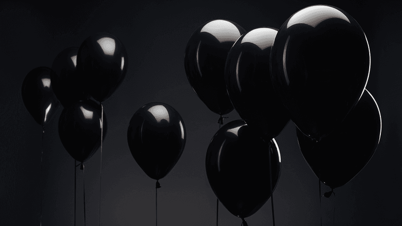 Several balloons floating in the air.