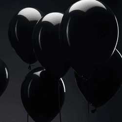 Several balloons floating in the air.