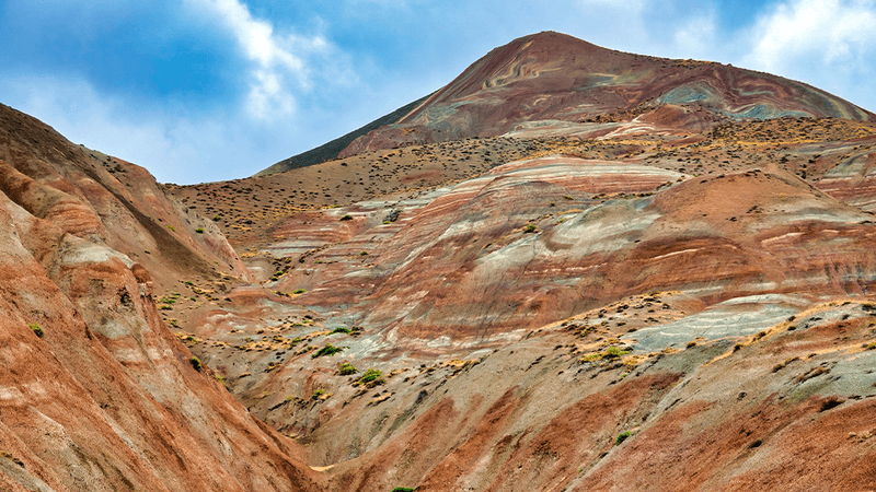 Red and white striped surface on a tall mountain