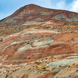Red and white striped surface on a tall mountain