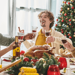 a group of friends having a drink around a busy dinner table