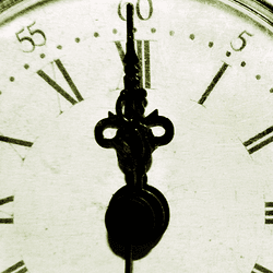 A clock face, with hands pointing towards 12.