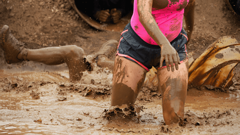 Marathon runners in mud.