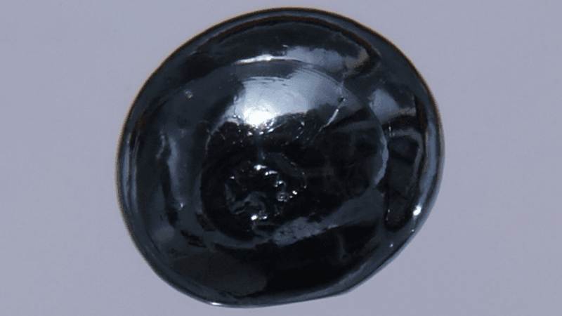 A black, shiny blob of osmium.