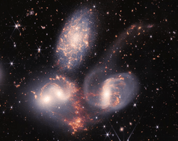 The JWST made Stephan's Quintet one of its five original images. The collision between one of the galaxies and three others is part of the reason the galaxies are so bright.