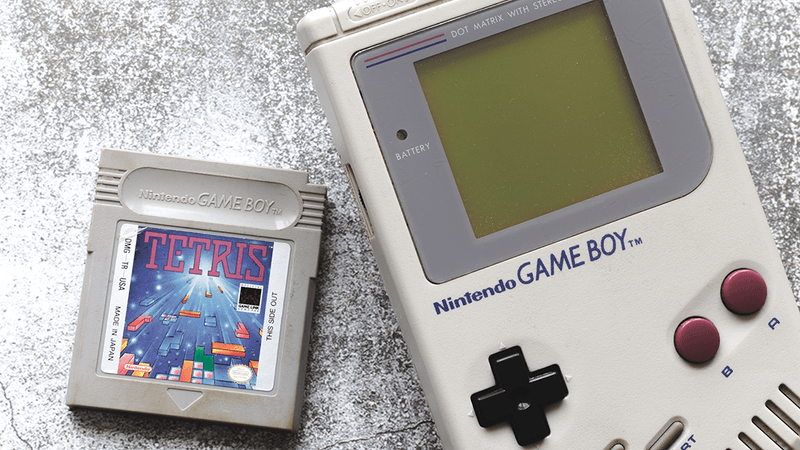 A Tetris cartridge next to a Nintendo Game Boy.
