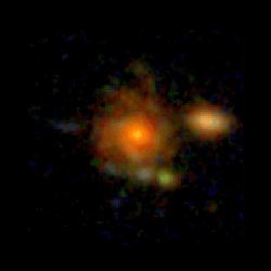 A pixelated face-on spiral galaxy sit a the center of the image. next to it a small elliptical is visible.