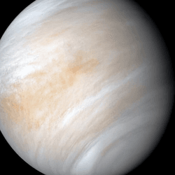 Venus is is completely covered in long hing turbulent clouds in this view showing most of the planet's disk