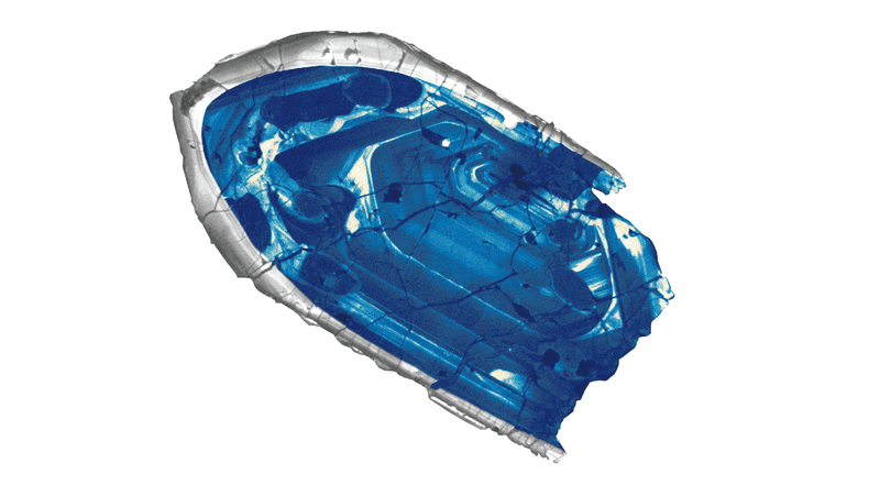 Microscope image of a small, blue zircon crystal found in Jack Hills, Australia, confirmed to be the oldest bit of the Earth's crust.